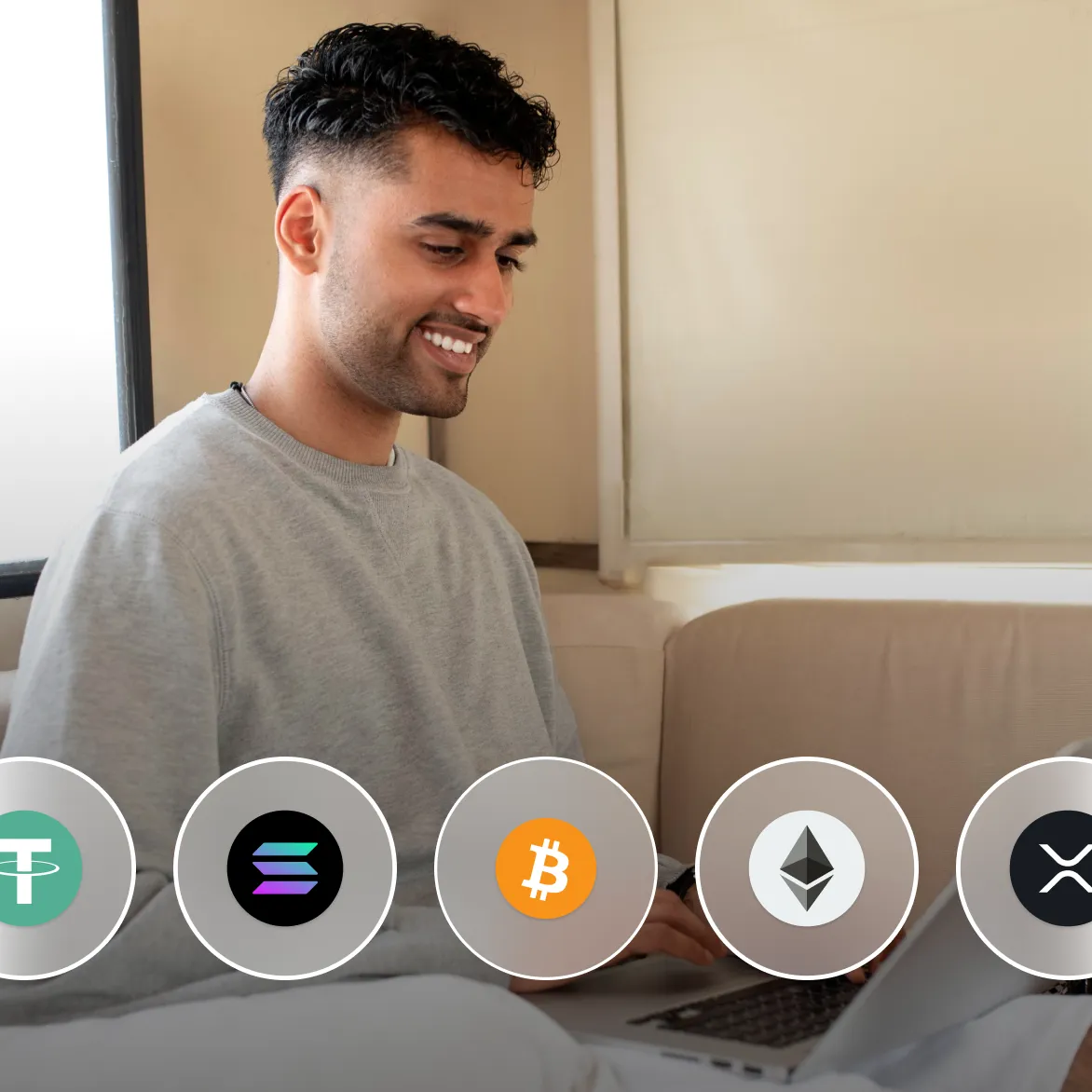 A man smiling looking at a laptop screen while trading crypto currencies on Deriv's MT5 platform.